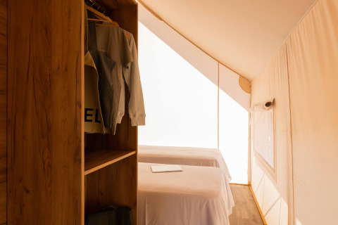 Interieur van een Glamping Family Plus safaritent bij Wecamp Cadaqués in Spanje, met twee bedden.