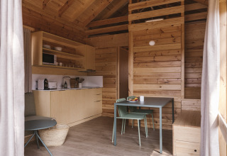Vista interior de la moderna tiny house Bungalow «Duplex» en Wecamp Cala Montgó, España, con diseño en madera.