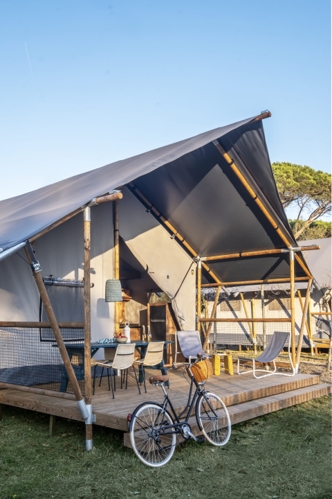 Safari tent Lodge 'Family Duplex' bij Wecamp Santa Cristina in Spanje met fiets en buitenveranda.