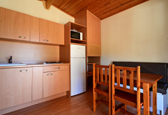 Kleine Küche mit Esstisch im Mobile Home Basic Family auf Wecamp Pedraforca in Spanien.