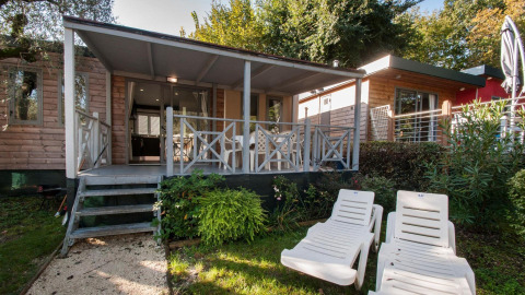 Modern Cottage Next XL Superior with covered terrace and sun loungers at Weekend Glamping Resort in Italy.