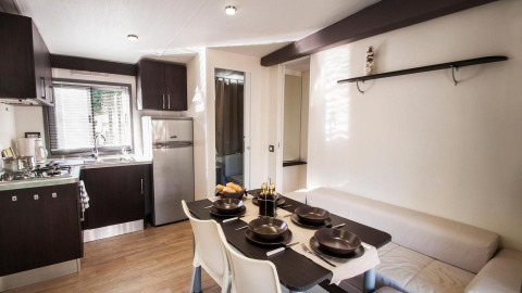 Modern kitchen and dining area in the Cottage Next XL Superior at Weekend Glamping Resort, Italy, well-lit and welcoming.