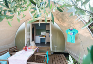 Coco Suite safari-tent bij Weekend Glamping Resort in Italië, met terras, eettafel en gezellige uitstraling.