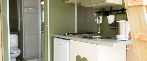 Compact kitchen and bathroom setup inside Airlodge 1 at Chianti Glamping Resort in Italy.