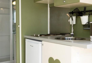 Compact kitchen and bathroom setup inside Airlodge 1 at Chianti Glamping Resort in Italy.