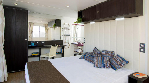 Binnenkant van de Cube Suite in Chianti Glamping Resort, Italië, met modern slaapgedeelte en bureau.