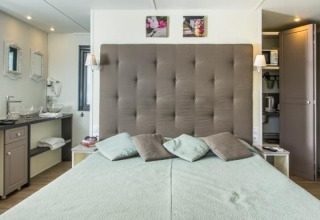 Moderne suitekamer in Cube Suite van Chianti Glamping Resort, Italië, met een gezellig bed en elegant design.