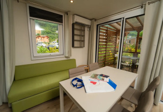 Interieurfoto van de Cube Suite XL chalet bij Lago Idro Glamping Boutique in Italië met bank en terras.