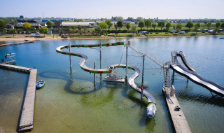 Overview of beach, lake and water slide - Villatent Camping Betuwestrand - Beesd, Gelderland, Netherlands