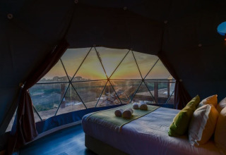 Zonsondergangzicht vanuit het bed in Dome House Duplex bij Wecamp Reserva Alecrim in Portugal met mooi uitzicht.