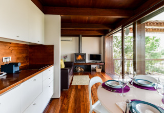 Binnenzicht op een moderne bungalow bij Wecamp Reserva Alecrim met eethoek, keuken en zitruimte.