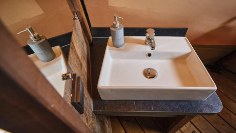 Moderne wastafel met zeepdispenser in de Tipi Lodge bij Trasimeno Glamping Resort, Italië.