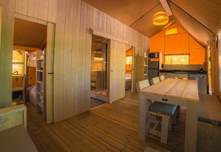Binnenkant van de Spotty Lodge Ranger safaritent op Trasimeno Glamping Resort met houten inrichting in Italië.