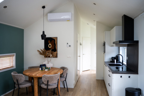 Cozy interior of a Wellness Cottage with dining area and kitchen at De Thijmse Berg in the Netherlands.