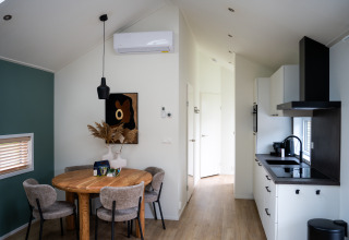 Cozy interior of a Wellness Cottage with dining area and kitchen at De Thijmse Berg in the Netherlands.
