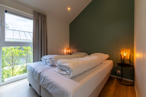 Bedroom at Wellness Cottage with private hot tub and sauna at De Thijmse Berg, Netherlands, cozy and bright.
