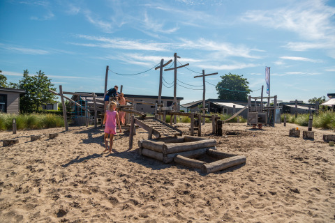 Des enfants jouent sur une aire de jeux sablonneuse à Dune Lodge, EuroParcs Parc du Soleil, Pays-Bas.