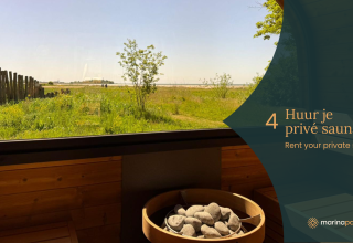 View from a sauna at a glamping accommodation with green fields, wooden fence, and private sauna info graphic