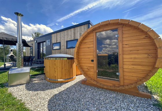 Modern tiny house at Holiday village SEEBLICK with outdoor sauna and hot tub by Eixendorfer See.
