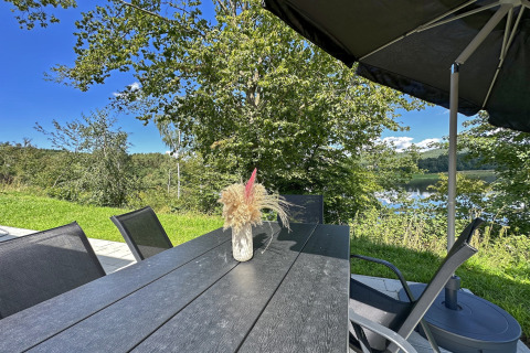 Udendørs spiseplads ved Holiday village SEEBLICK - Tiny Chalet am Eixendorfer See, udsigt til sø.