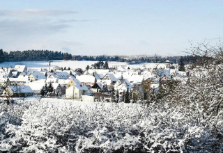 Winterse blik op een besneeuwd vakantiedorp bij Holiday park Lauterdörfle, Duitsland.