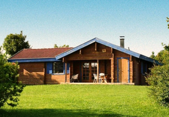 Wooden chalet in Holiday Park Lauterdörfle, Type D Neckar, for 6 people, 70 sqm, on lush green lawn.