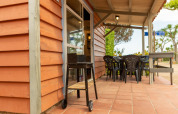Outdoor patio at Camping del Mar BUNGALOW MEDITERRANI, Spain, with barbecue, table and chairs.