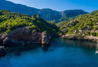 Stunning coastal view from Camping del Mar BUNGALOW MEDITERRANI in Spain with green hills and blue waters.