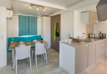 Heldere keuken en eethoek in CAMPING INTERPALS- Bungalow Sa Riera, Spanje, met moderne inrichting.