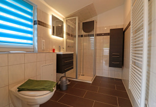 Modern bathroom in the cabin Räuberkuhle Koserow, Germany, featuring a shower and contemporary furnishings.