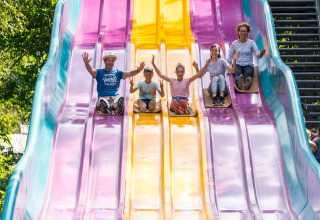 Family enjoying a colorful slide at the safari tent Tongasoa-Lodges 4 Personen in Germany.