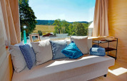 Cozy sofa with blue pillows at Haus Wasser cabin in Germany, overlooking scenic countryside views.