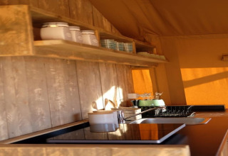 Rustieke keuken in safaritent Tenda 1 in Italië met houten planken, kookplaat, gootsteen en zonlicht