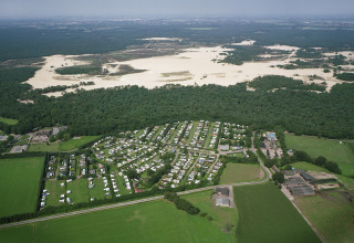 Aerial view of Recreation park Duinhoeve 7 in the Netherlands, bordered by fields, forest and sand dunes.