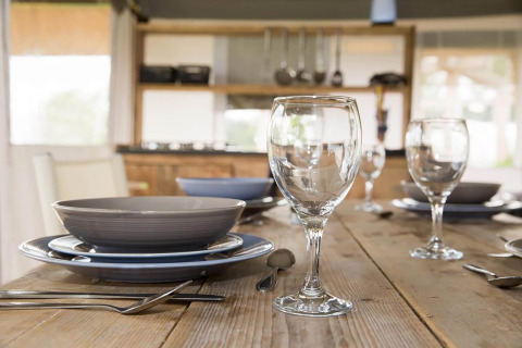 Table setting with plates, glasses and cutlery in Safari tent 'Noflik' in the Netherlands.