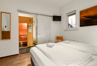 Bedroom in Water park «De Bloemert 7» in the Netherlands featuring a sauna, double bed, and modern decor.