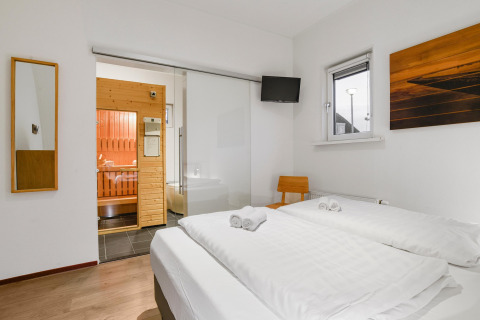Schlafzimmer in Water park «De Bloemert 7» in den Niederlanden mit Sauna, Doppelbett und TV.