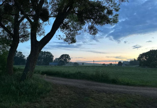 Photo de paysage à House Gajewo en Podlasie, Suède, avec champs, arbres et ciel de coucher de soleil paisible.