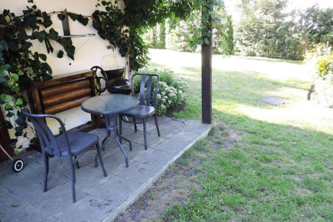 Outdoor terrace at Bungalows, Lubin-Type B (Henryk) in Germany with table, chairs, and a grassy garden.