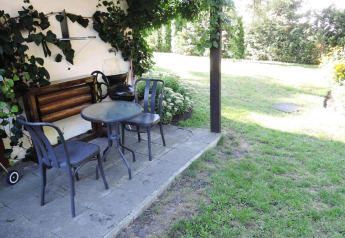 Terraza exterior en Bungalows, Lubin-Type B (Henryk) en Alemania con mesa, sillas y jardín verde.