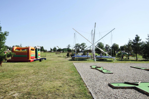 Outdoor playground with bouncy castle, trampolines, and mini-golf at At «słonecznikiem» in Germany.