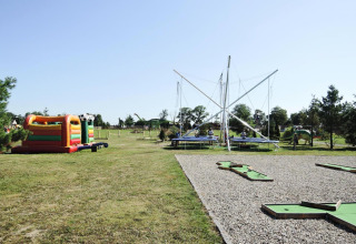 Outdoor playground with bouncy castle, trampolines, and mini-golf at At «słonecznikiem» in Germany.