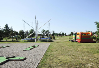 Outdoor playground featuring trampolines, bouncy castle, and mini golf at At «słonecznikiem» cabin, Germany.