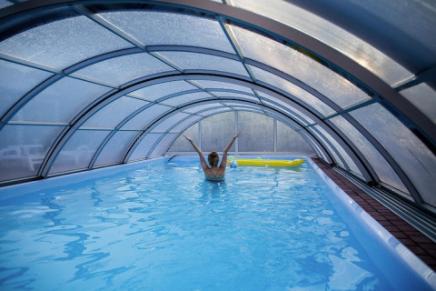 Indoor pool with a transparent dome roof at Holiday Resort Wiselka-35 sqm Type A in Germany.