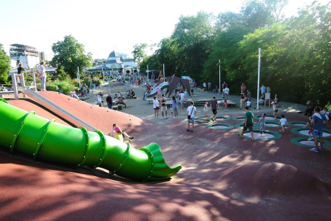 Children playing on a playground with a slide and trampolines at holiday homes in Miedzyzdroje, Germany.