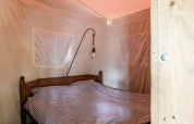 Bedroom at Duynlodge - Duynpark in the Netherlands featuring a wooden bed frame and checkered bedding.