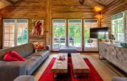 Cozy living room at 'Paalchalet 723' lodge in Belgium, with rustic wood interior and garden view.