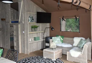 Interior of safari tent Veluwe Lodge at Camping Samoza in the Netherlands, featuring rustic wooden décor.