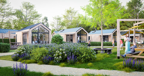 Moderne houten lodges omgeven door bloeiende tuinen bij Dordogne Deluxe, mensen ontspannen buiten.