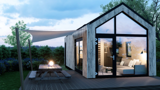 Moderna cabaña Dordogne Deluxe en La Draille, Francia, con grandes ventanales, terraza y zona de picnic.